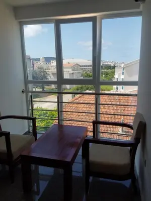 a room with a table and chairs and a large window at Villa Swan in Bar