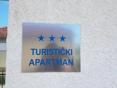 a sign on the side of a building with stars at Villa Swan in Bar