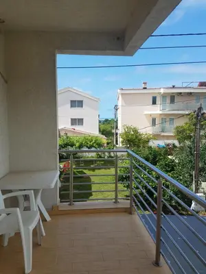 a balcony with a table and a view of a building at Villa Swan in Bar