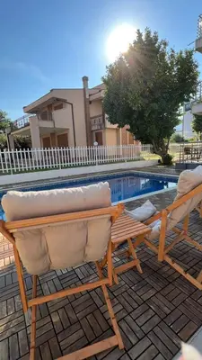 two lounge chairs sitting next to a swimming pool at Villa Swan in Bar