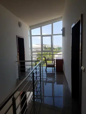 a room with a balcony with a chair and a window at Villa Swan in Bar