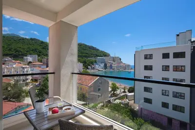 an apartment balcony with a view of the city at Apartments Djuro Rafailovic in Budva