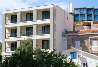 an apartment building with balconies on the side at Apartments Djuro Rafailovic in Budva