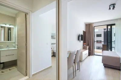 a living room and dining room with a sliding glass door at Apartments Djuro Rafailovic in Budva