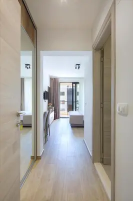 a hallway with a door leading to a bedroom at Apartments Djuro Rafailovic in Budva