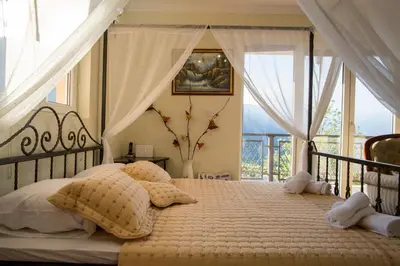 a bedroom with a bed with pillows and a window at Apartments Golden View in Kotor