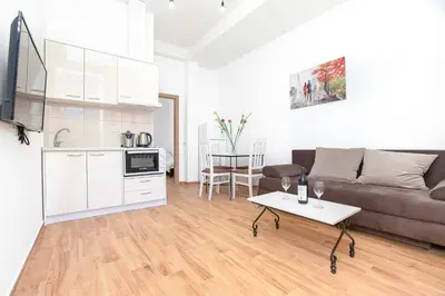 a living room with a couch and a table at Apartments Golden View in Kotor