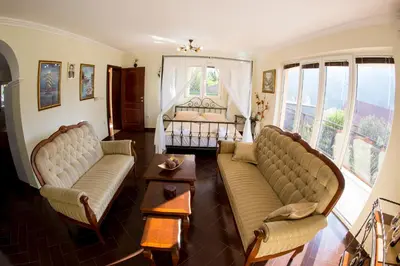 a living room with two couches and a bed at Apartments Golden View in Kotor