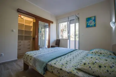 a bedroom with a bed with a blue comforter at Magnolia Old Town in Kotor