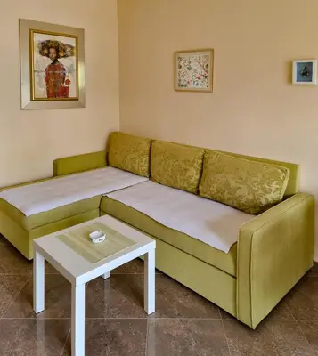 a living room with a green couch and a table at Luxury Apartment Maja in Tivat