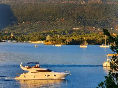 a white boat floating on a large body of water at Luxury Apartment Maja in Tivat