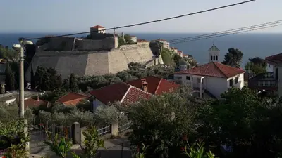 a view of a town with houses and the ocean at Luka Apartment in Ulcinj
