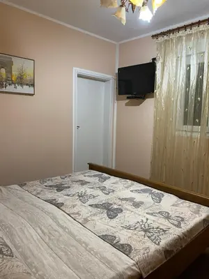 a bedroom with a bed and a flat screen tv at Luka Apartment in Ulcinj