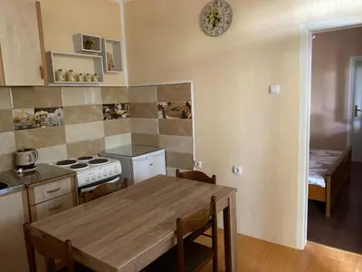 a kitchen with a table and a stove top oven at Luka Apartment in Ulcinj