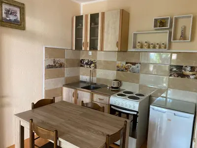 a kitchen with a table and a stove top oven at Luka Apartment in Ulcinj