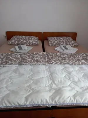 two beds with white sheets and pillows on them at Guesthouse Nikoleta in Kotor