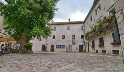 a person standing in front of a large building at Guesthouse Nikoleta in Kotor