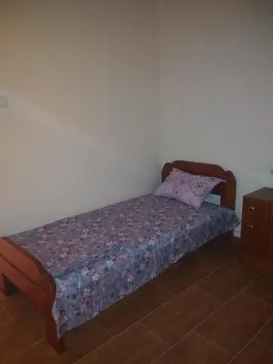 a bedroom with a bed with a pillow on it at Apartman 