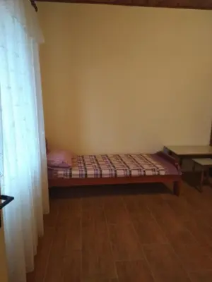 a room with a bed in the corner of a room at Apartman 
