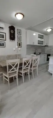 a kitchen with a table and chairs in a room at Royal Apartment Bar in Bar