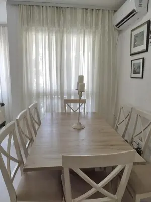 a wooden table and chairs in a dining room at Royal Apartment Bar in Bar