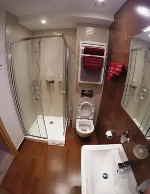 a bathroom with a shower and a toilet and a sink at Red Lux in Budva