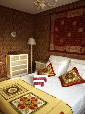 a bedroom with a bed with pillows on it at Red Lux in Budva