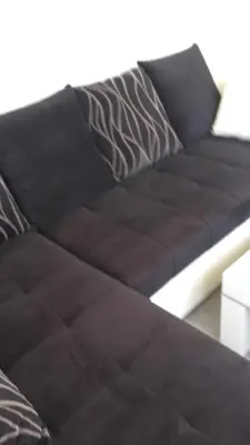 a brown couch sitting in a living room at Apartments Petrovic in Krimovice
