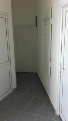an empty hallway with two doors and a tiled floor at Apartments Petrovic in Krimovice