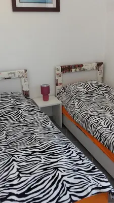 two beds sitting next to each other in a room at Apartments Petrovic in Krimovice