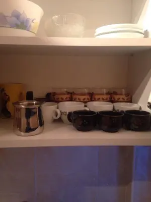 a shelf with various pots and pans on it at Apartment La Romana in Podgorica
