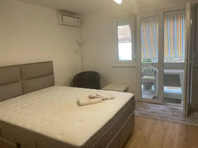 a bedroom with a bed with two towels on it at Apartment La Romana in Podgorica