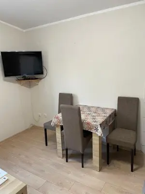 a room with a table and two chairs and a tv at Apartment Lazar & Marco in Podgorica