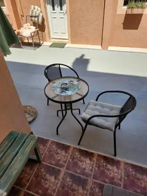 a patio with a table and a chair and a table and chairs at Apartments Sandra 2 in Kotor