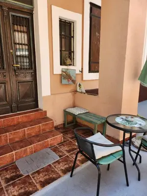 a porch with a table and a chair and a door at Apartments Sandra 2 in Kotor