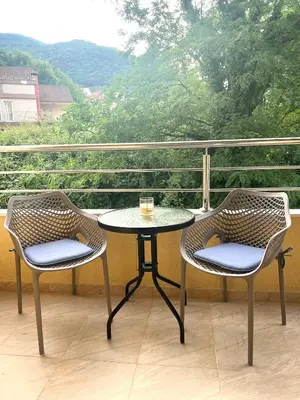 a table and two chairs on a balcony with a view at Bojovic's Apartment in Budva