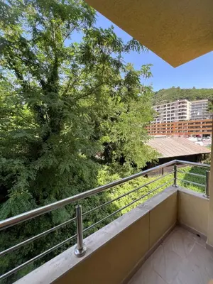 a balcony with a view of a tree at Bojovic's Apartment in Budva