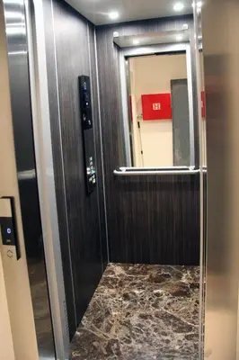 a bathroom with a mirror and a door with a marble floor at Vila V Lux Apartments in Petrovac na Moru