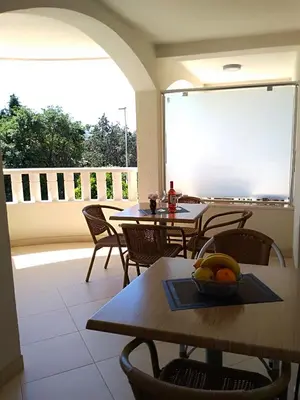 a room with tables and chairs and a large window at Vila V Lux Apartments in Petrovac na Moru