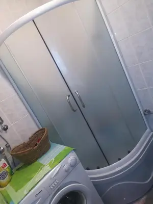 a washing machine in a bathroom with a mirror at Apartment Sara in Podgorica