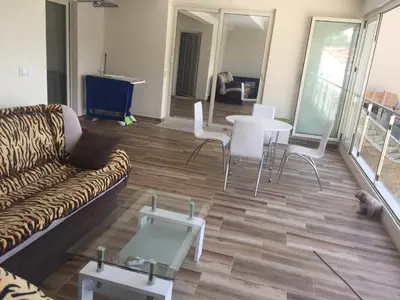 a living room with a couch and a table and chairs at Apartment Galina Przno in Budva