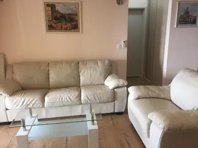a living room with a couch and a glass table at Apartment Galina Przno in Budva