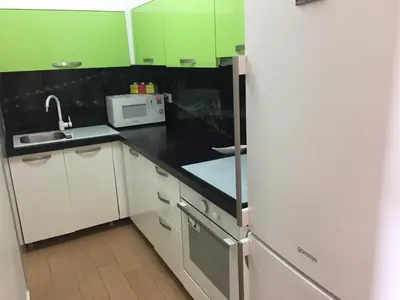a kitchen with white cabinets and a black counter top at Apartment Galina Przno in Budva