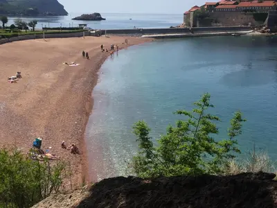 a group of people on a beach near the water at Apartment Galina Przno in Budva