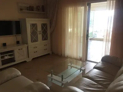 a living room with a couch and a glass coffee table at Apartment Galina Przno in Budva