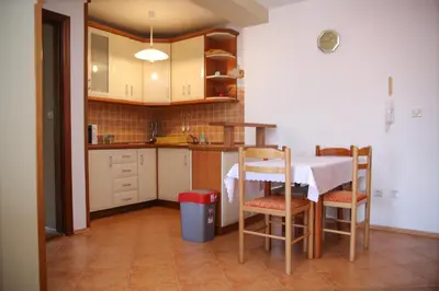 a small kitchen with a table and chairs in a room at Ana in Budva