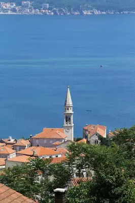 a building with a clock tower on top of a city at Ana in Budva
