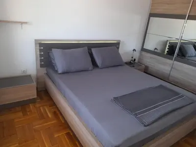 a bedroom with a large bed with purple pillows at Ana in Budva