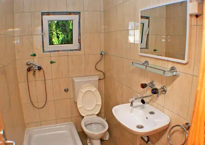 a bathroom with a toilet and a sink at Apartmani Palma in Sutomore