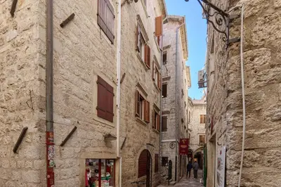 an alley in an old town with buildings at G-Apart in Kotor